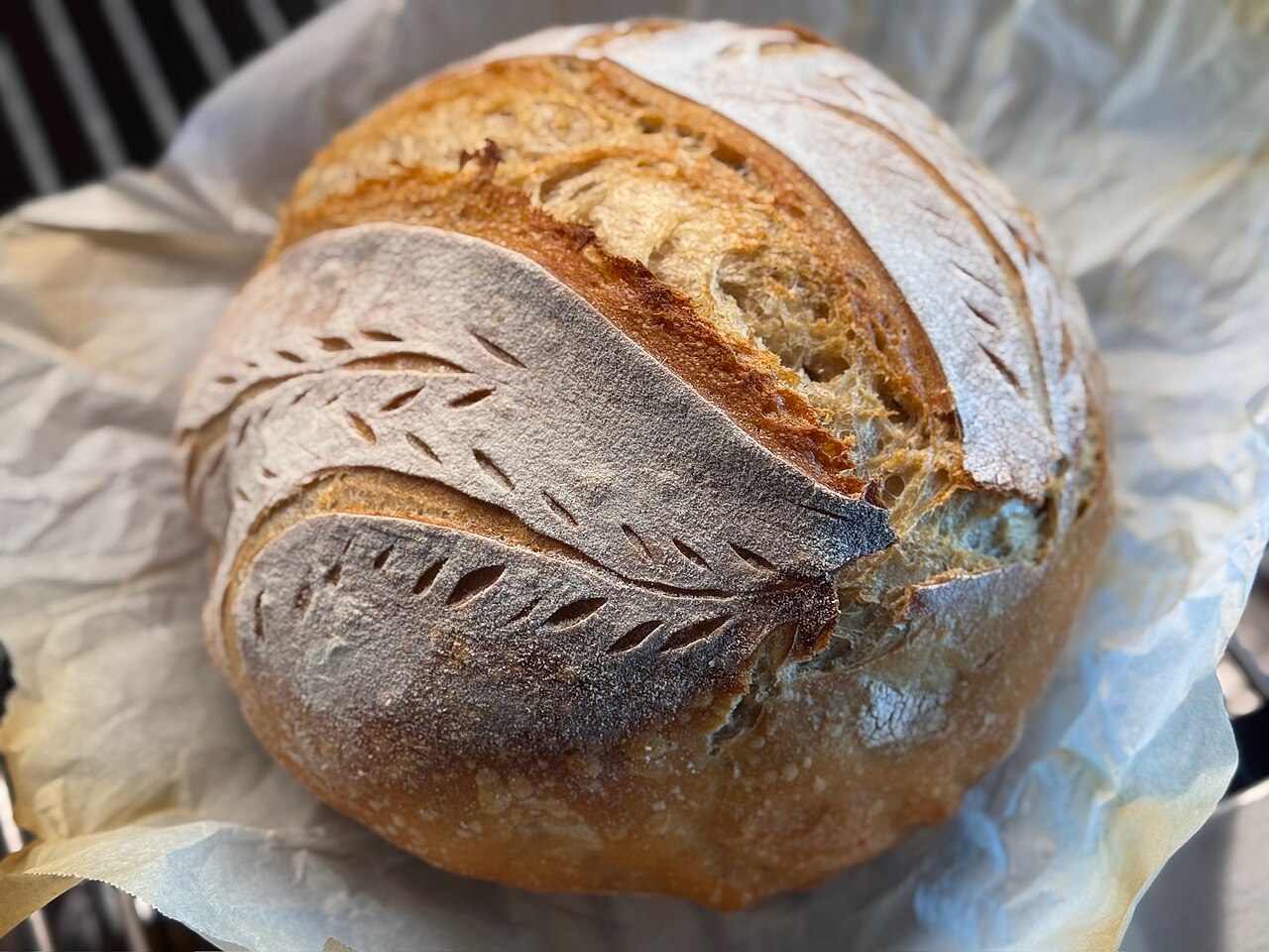 Round artisan sourdough loaf dusted with flour